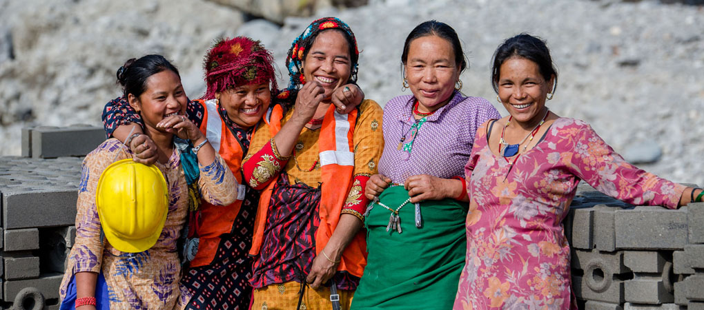 Women involved in compressed earth brick construction in Nepal